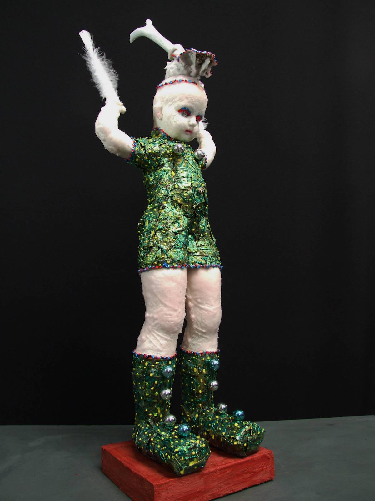 ' Learning to Fly ' from the series , " My little people that have come down from the hills....." Medium Mixed Media ------ created from found objects, put together in my ' Frankenstein ' way, then dressed and highly decorated, including thinly rolled treated lead, wax, glow paint, altered objects, plus some inspiration....... Size 42 inches / 107 centimetres tall